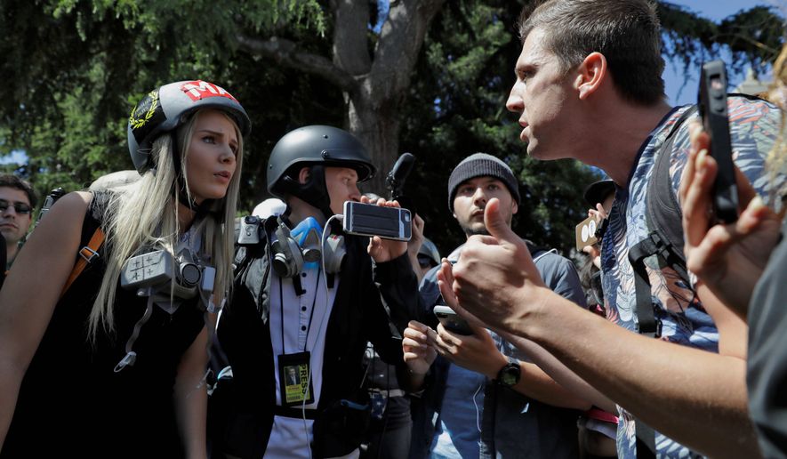 Demonstrators with opposing views argue at a free speech rally on the University of California, Berkeley campus. Despite political differences, 76 percent say there&#39;s a greater danger of political violence today. (Associated Press)