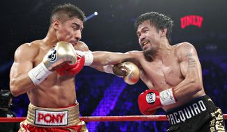 Manny Pacquiao, right, of the Philippines, hits Jessie Vargas during their WBO welterweight title boxing match, Saturday, Nov. 5, 2016, in Las Vegas. (AP Photo/Isaac Brekken)