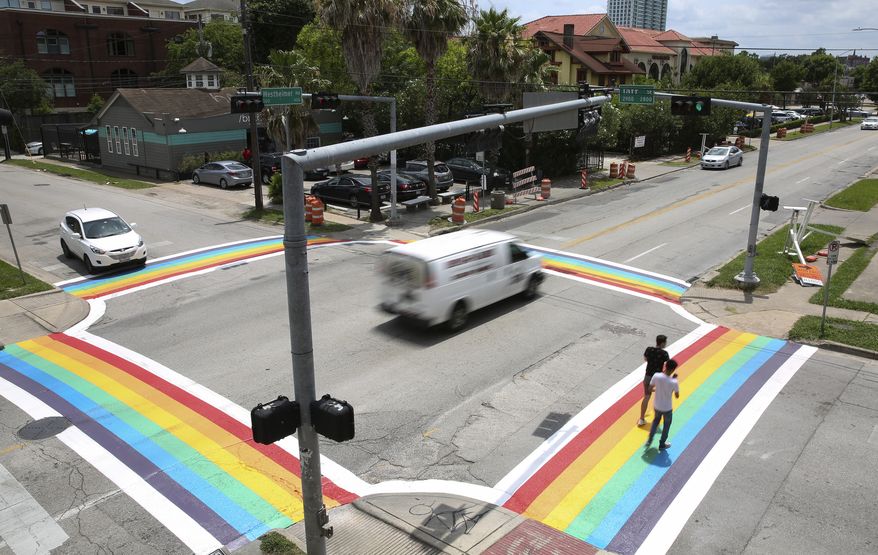 The completed four Rainbow Flag crosswalks at the intersection of Westheimer Road and Taft Street have became a popular spot for photographs Sunday, June 18, 2017, in Houston. (Yi-Chin Lee/Houston Chronicle via AP)