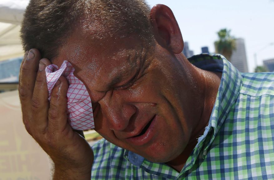 Steve Smith wipes sweat from his face as temperatures climb to near-record highs in Phoenix on Monday, June 19, 2017. (AP Photo/Ross D. Franklin)