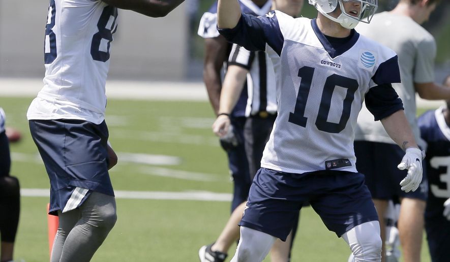 In this photo taken June 13, 2017, Dallas Cowboys receiver Ryan Switzer (10) gets a high five from fellow wide receiver Dez Bryant during an NFL football practice at the team's training facility in Frisco, Texas. (AP Photo/Jaime Dunaway)