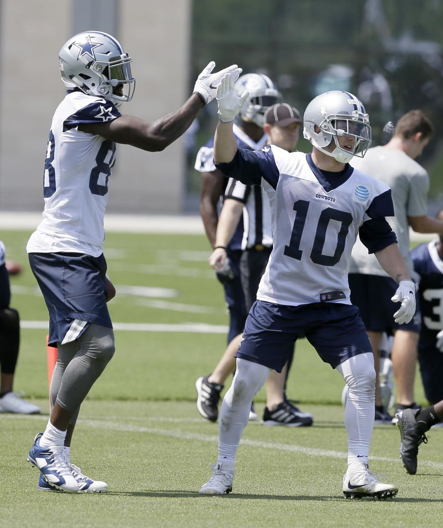In this photo taken June 13, 2017, Dallas Cowboys receiver Ryan Switzer (10) gets a high five from fellow wide receiver Dez Bryant during an NFL football practice at the team's training facility in Frisco, Texas. (AP Photo/Jaime Dunaway)