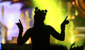 A woman dances as Hardwell performs at the Kinetic Field stage during the opening night of the Electric Daisy Carnival at the Las Vegas Motor Speedway in Las Vegas on Saturday, June 17, 2017. (Chase Stevens/Las Vegas Review-Journal via AP)