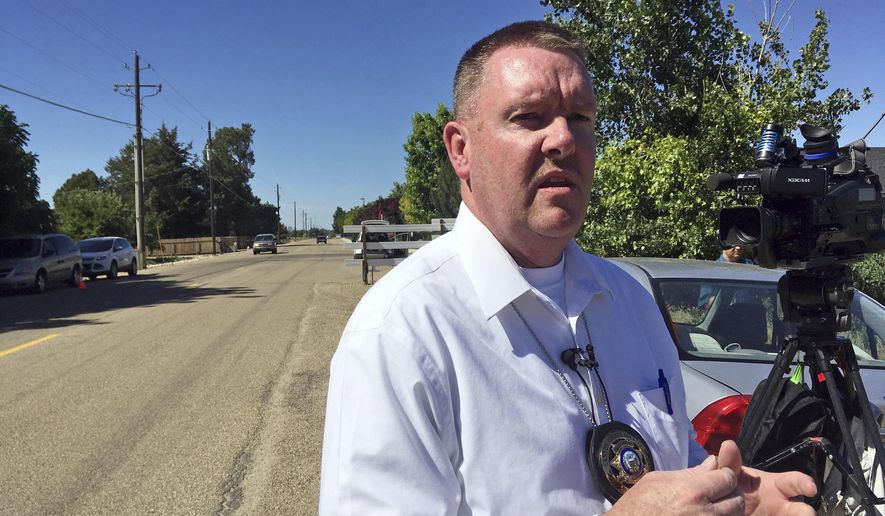 Chief Deputy Marv Dashiell with the Canyon County Sheriff's Office speaks on Monday, June 19, 2017, outside a home in Caldwell, Idaho. Police say three people were found dead inside a home and authorities are investigating the deaths as possible homicides. (AP Photo/Kimberlee Kruesi).