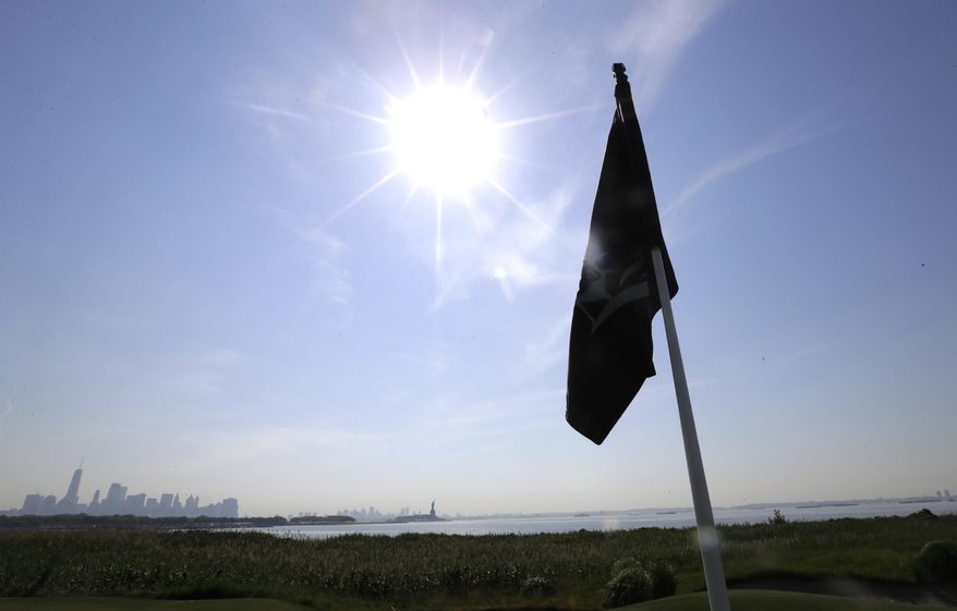 In a photo taken Tuesday, June 13, 2017, in Jersey City, N.J., the sun shines on the clubhouse at Liberty National Golf Club, which will host the Presidents Cup in late September. (AP Photo/Julio Cortez)
