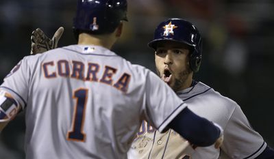 Houston Astros&#39; George Springer, right, celebrates with Carlos Correa (1) after hitting a home run off Oakland Athletics&#39; John Axford in the eighth inning of a baseball game Monday, June 19, 2017, in Oakland, Calif. (AP Photo/Ben Margot)