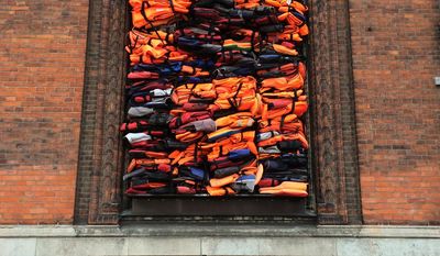 Part of a new artwork by Chinese dissident artist Ai Weiwei, entitled ‘Soleil Levant&#39; (sunrise in French) made from over 3,500 lifejackets discarded by migrants on the Greek island of Lesbos, following its official inauguration at Copenhagen’s Kunsthal Charlottenborg museum in Copenhagen, Denmark, Tuesday June 20, 2017.  Weiwei has barricaded the windows of the museum for his provocative new artwork as a striking reminder of the ongoing migrant crisis, inaugurated Tuesday on World Refugee Day.  (AP Photo / James Brooks)