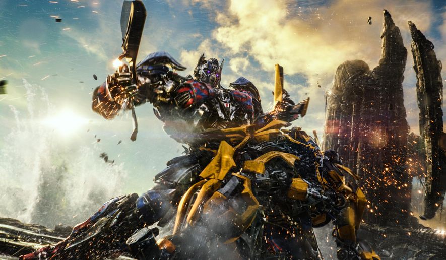 This image released by Paramount Pictures shows Optimus Prime and Bumblebee, foreground, in a scene from, "Transformers: The Last Knight." (Paramount Pictures/Bay Films via AP)
