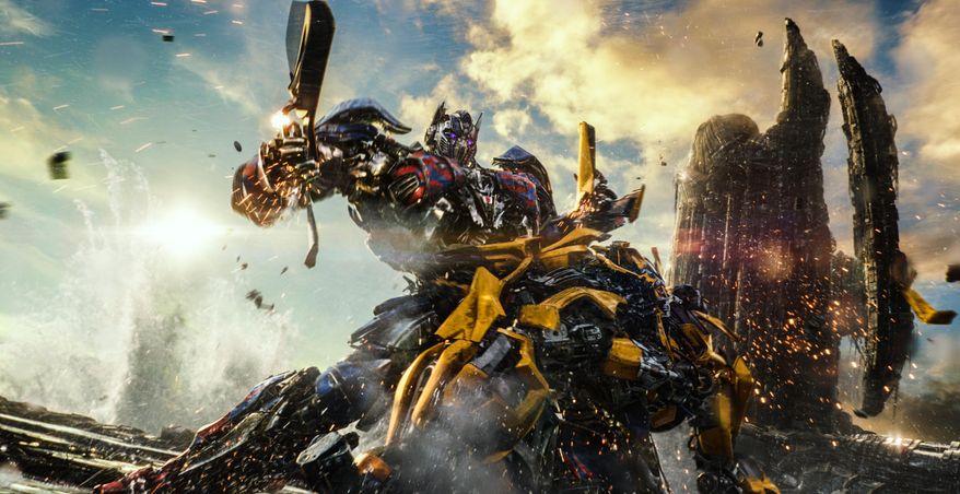 This image released by Paramount Pictures shows Optimus Prime and Bumblebee, foreground, in a scene from, "Transformers: The Last Knight." (Paramount Pictures/Bay Films via AP)