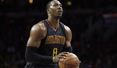 FILE - In this March 29, 2017, file photo, Atlanta Hawks&#39; Dwight Howard prepares to shoot a free throw during the team&#39;s NBA basketball game against the Philadelphia 76ers in Philadelphia. A person familiar with the situation says the Charlotte Hornets have reached an agreement to acquire center Howard from the Hawks. The Hawks are sending Howard and the No. 31 overall pick in Thursday&#39;s NBA draft to Charlotte for center Miles Plumlee, shooting guard Marco Belinelli and the 41st pick, the person told The Associated Press on condition of anonymity Tuesday, June 20, because the trade is not yet official. (AP Photo/Matt Slocum, File)