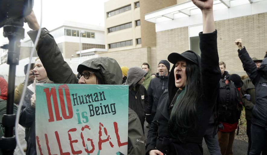 FILE--In this Feb. 27, 2017, file photo, protestors chant during a rally in Portland, Ore.outside the Immigration and Customs Enforcement building. Oregon's Legislature has taken a step closer to defying a federal government crackdown on illegal immigration, with the House passing a bill that seeks to restrict the ability of state and local agencies, including law enforcement, to inquire about a person's immigration status and prohibiting public agencies from disclosing information to federal officials except in certain circumstances. (AP Photo/Don Ryan, file)