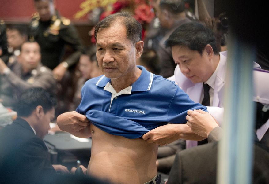Doctors check the health of Wattana Pumret, 61, as he arrives at police headquarters for a press conference in Bangkok, Thailand, Tuesday, June 20, 2017. Wattana, who was arrested for the bombing of an army hospital in Bangkok, says he carried out the attack that wounded 21 people to symbolize defiance against Thailand&#39;s ruling military junta. (AP Photo/Sakchai Lalit)