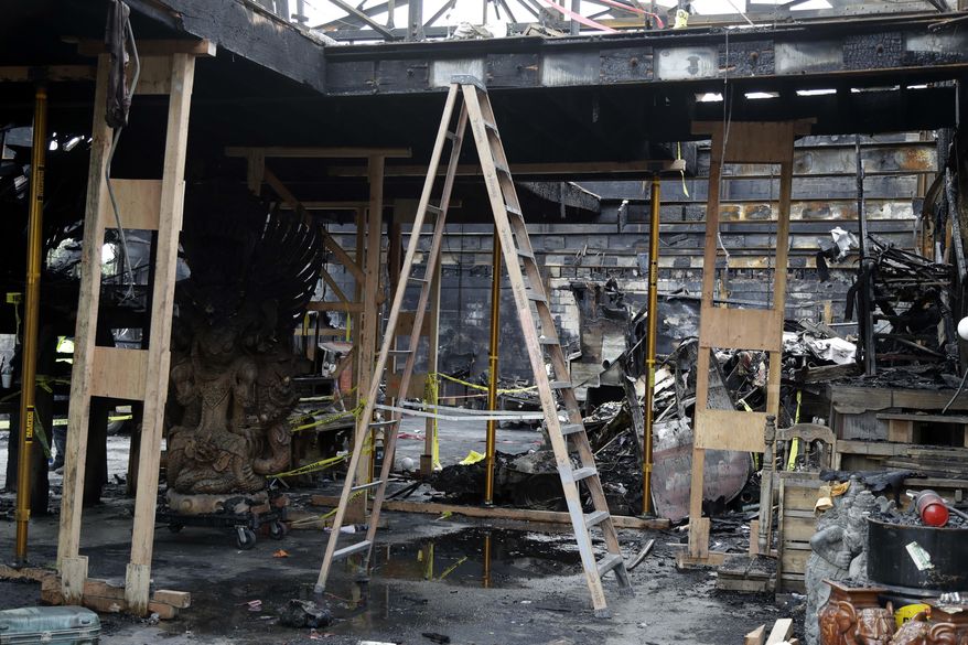 File - In this Dec. 13, 2016 file photo, a ladder stands inside the charred Ghost Ship warehouse in Oakland, Calif. More than six months after the Dec. 2 blaze at the warehouse that authorities said was illegally converted into living quarters, the Oakland Fire Department has released a 50-page report filled with harrowing details of death and panic as the flames and deadly smoke spread. The report contains many previously unknown details about the nation's deadliest structure fire in more than 14 years and says investigators could not determine the cause of the blaze due to extensive fire damage. (AP Photo/Marcio Jose Sanchez, File)
