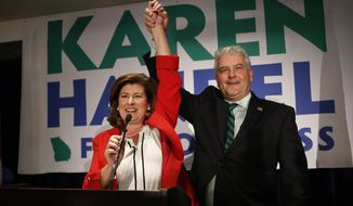 Karen Handel, Republican candidate for Georgia&#39;s 6th District Congressional seat, celebrates with her husband Steve as she declares victory during an election-night watch party in Atlanta on Tuesday, June 20, 2017. (Associated Press)