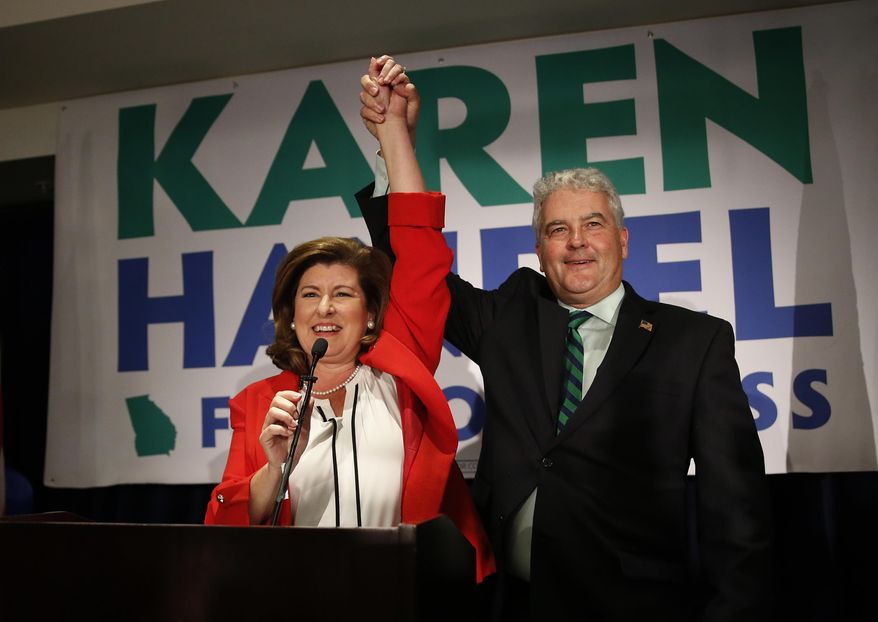 Karen Handel, Republican candidate for Georgia's 6th District Congressional seat, celebrates with her husband Steve as she declares victory during an election-night watch party in Atlanta on Tuesday, June 20, 2017. (Associated Press)