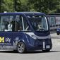 A driverless shuttle carries passengers at the University of Michigan, Wednesday, June 21, 2017, in Ann Arbor, Mich. Two driverless shuttles will begin operating at the university this fall. The tall, airy, 15-passenger shuttles will carry students and staff in a two-mile loop on campus roads alongside regular traffic. The shuttle will be free and insured by the university. The electric shuttles are made by French startup NAVYA, which has deployed 25 shuttles worldwide since last year and is operating them on campuses in Australia and Japan. (AP Photo/Carlos Osorio)