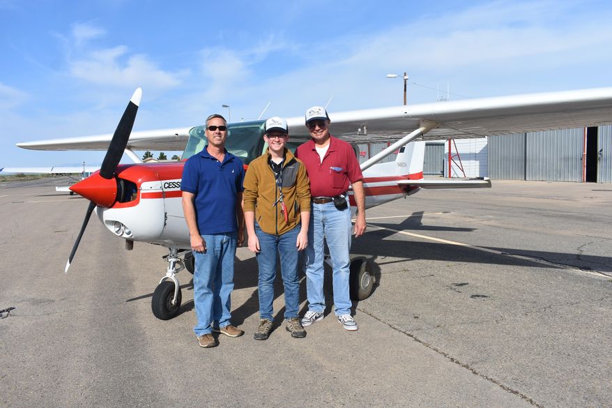 ADVANCE FOR WEEKEND EDITIONS - In this June 8, 2017, photo, New Mexico Aviation Aerospace Association President Bill Schuert, Bo Perry and Bob Pavelka of Ed's Flying Service stand together after Perry's solo flight at the Alamogordo-White Sands Regional Airport in Alamogordo, N.M. Perry, a student at Alamogordo High School, has been working hard for the last five months learning to fly powered aircraft at Ed's Flying Service, located at the Alamogordo-White Sands Regional Airport. One June morning, Perry took a big step in his training and completed his first solo flight. (Tara Melton/Alamogordo Daily News via AP)