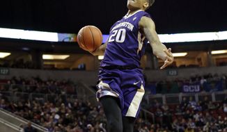 FILE - In this Dec. 22, 2016, file photo, Washington&#x27;s Markelle Fultz winds-up to dunk against Seattle in an NCAA college basketball game, in Seattle. Fultz is the likely No. 1 pick in the NBA Draft on Thursday night, June 22. (AP Photo/Elaine Thompson, File)