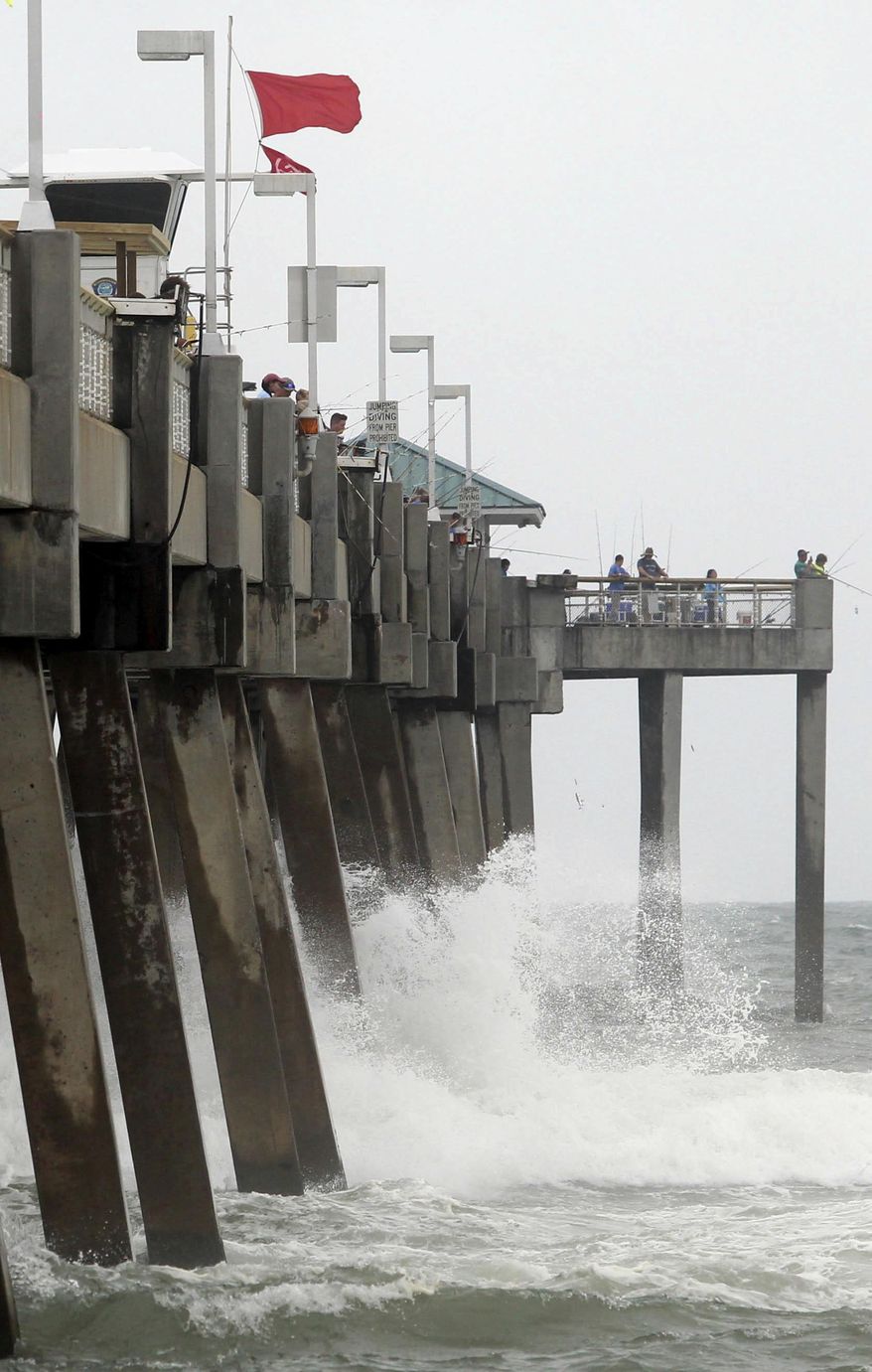 Waves crash against the Okaloosa Island Pier near Fort Walton Beach, Fla, Wednesday, June 21, 2017, as heavy surf brought on by Tropical Storm Cindy kept the waters closed to swimmers. (Michael Snyder/Northwest Florida Daily News via AP)
