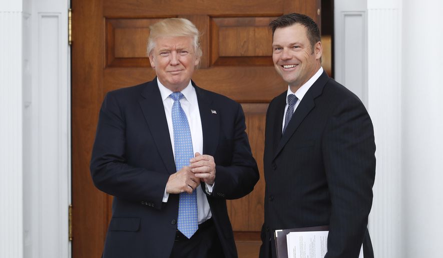 In this Nov. 20, 2016, file photo, Kansas Secretary of State Kris Kobach, right, holds a stack of papers as he meets with then President-elect Donald Trump at the Trump National Golf Club Bedminster clubhouse in Bedminster, N.J. (AP Photo/Carolyn Kaster, File) **FILE**
