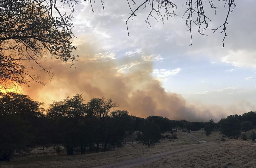 In this Tuesday, June 20, 2017, photo, provided by Ann Alden shows a wildfire, locally called the Encino Fire, in Sonoita, Ariz. An extreme heat wave in the Southwest U.S. made the fight against a series of wildfires more difficult Wednesday. (Ann Alden via AP)