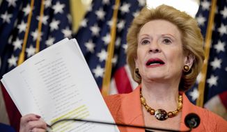 Sen. Debbie Stabenow, D-Mich., holds up a copy of the proposed Senate Republican health bill as she discusses the effects of the proposed Republican health care legislation on families at a news conference on Capitol Hill in Washington, Thursday, June 22, 2017. (AP Photo/Andrew Harnik)