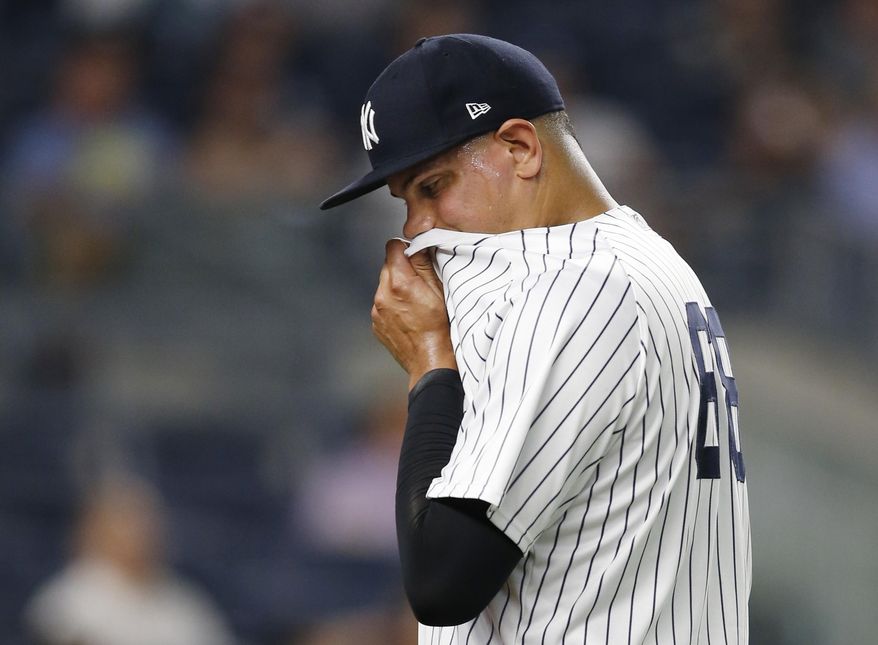 New York Yankees relief pitcher Dellin Betances wipes his face on his jersey while leaving the mound after allowing two runs during the seventh inning of the team's baseball game against the Los Angeles Angels in New York, Thursday, June 22, 2017. (AP Photo/Kathy Willens)