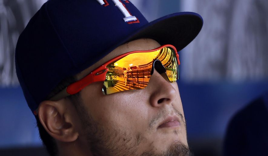 Texas Rangers' Yu Darvish, left, of Japan, watches from the dugout during the sixth inning of a baseball game against the Toronto Blue Jays, Thursday, June 22, 2017, in Arlington, Texas. (AP Photo/Tony Gutierrez)