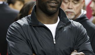 FILE - In this Sunday, Jan. 1, 2017, file photo, former Atlanta Falcons quarterback Michael Vick stands on the sidelines before the first half of an NFL football game between the Falcons and the New Orleans Saints, in Atlanta. Life after football hits some NFL players harder than others. Michael Vick, Steve Smith and Justin Forsett are adjusting to their post-NFL careers nicely. (AP Photo/John Bazemore, File)