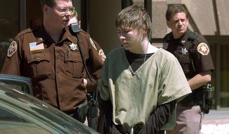FILE - In a May 4, 2006 file photo, Brendan Dassey, center, is lead out of the Manitowoc County Courthouse following his motion hearing in Manitowoc, Wis. A three-judge panel from the 7th Circuit on Thursday, June 22, 2017 affirmed that Dassey, a Wisconsin inmate featured in the Netflix series &amp;quot;Making a Murderer&amp;quot; was coerced into confessing and should be released from prison. Dassey was sentenced to life in prison in 2007 in photographer Teresa Halbach&#39;s death two years earlier.  (Eric Young/Herald-Times Reporter via AP, File)