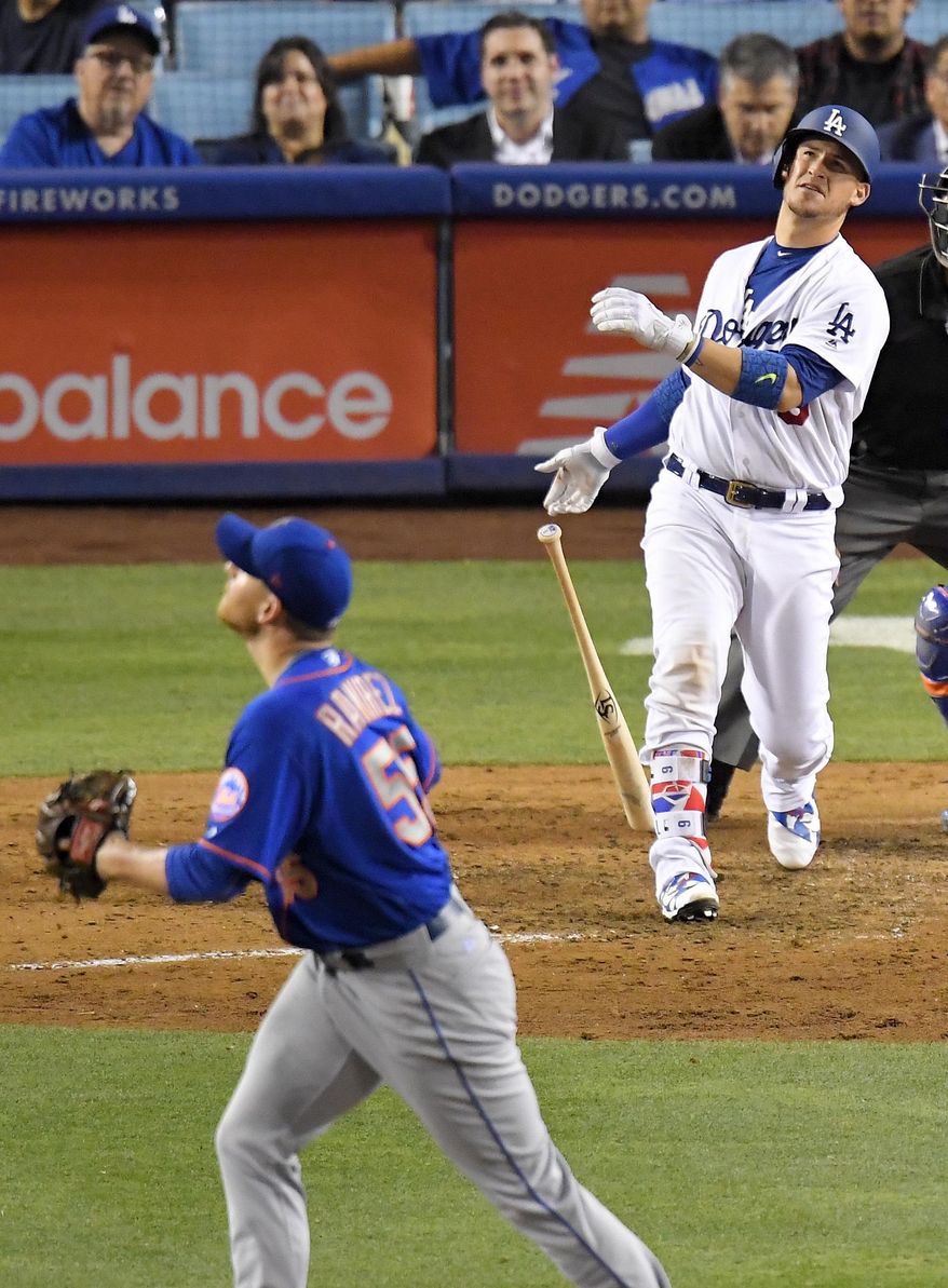Los Angeles Dodgers' Yasmani Grandal watches his solo home run off New York Mets relief pitcher Neil Ramirez watches during the eighth inning of a baseball game, Wednesday, June 21, 2017, in Los Angeles. (AP Photo/Mark J. Terrill)