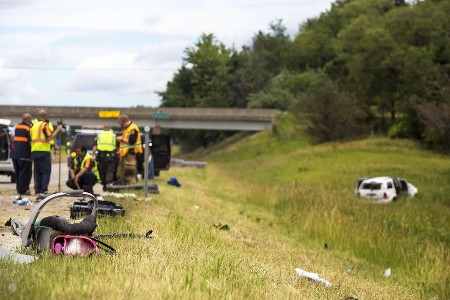 In this Wednesday, June 21, 2017 photo, a car seat lies on the ground at the scene of a crash on U.S. 131, which caused multiple critical injuries, in Kalamazoo, Mich. (Carly Geraci /Kalamazoo Gazette-MLive Media Group via AP)