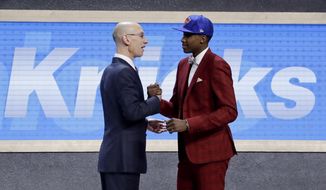 Frank Ntilikina is congratulated by NBA Commissioner Adam Silver after being selected by the New York Knicks as the eighth pick overall during the NBA basketball draft, Thursday, June 22, 2017, in New York. (AP Photo/Frank Franklin II)