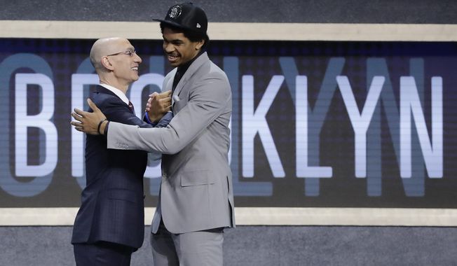 Texas center Jarrett Allen is congratulated by NBA Commissioner Adam Silver after being selected by the Brooklyn Nets as the 22nd pick overall during the NBA basketball draft, Thursday, June 22, 2017, in New York. (AP Photo/Frank Franklin II)