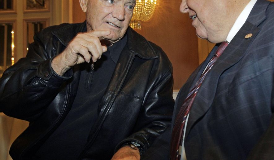 FILE- In this Dec. 6, 2010, file photo, Hall of Fame football coach Frank Kush, left, speaks to former Marshall University coach Jack Lengyel at the 2010 Eddie Robinson Coach of the Year press conference in New York. Kush, the fearsome coach who transformed Arizona State from a backwater football program into a powerhouse, has died, Arizona State confirmed Thursday, June 22, 2017. He was 88. (AP Photo/Kathy Willens, File)