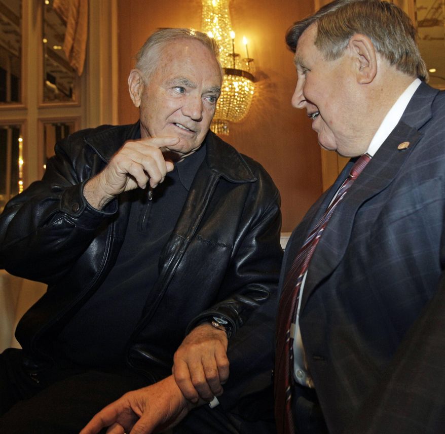 FILE- In this Dec. 6, 2010, file photo, Hall of Fame football coach Frank Kush, left, speaks to former Marshall University coach Jack Lengyel at the 2010 Eddie Robinson Coach of the Year press conference in New York. Kush, the fearsome coach who transformed Arizona State from a backwater football program into a powerhouse, has died, Arizona State confirmed Thursday, June 22, 2017. He was 88. (AP Photo/Kathy Willens, File)