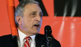 FILE - In this Nov. 2, 2010, file photo, Republican gubernatorial candidate Carl Paladino holds a baseball bat as he concedes the election in Buffalo, N.Y. Paladino, a one-time candidate for governor of New York who publicly insulted former President Barack Obama and his wife, may be booted off the Buffalo School Board. (AP Photo/David Duprey, File)