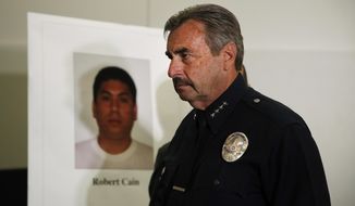 Los Angeles Police Chief Charlie Beck walks past a display board showing an image of officer Robert Cain after a news conference Thursday, June 22, 2017, in Los Angeles. Cain has been arrested for allegedly having sex with a 15-year-old cadet who&#39;s suspected of joyriding in stolen patrol cars. (AP Photo/Jae C. Hong)