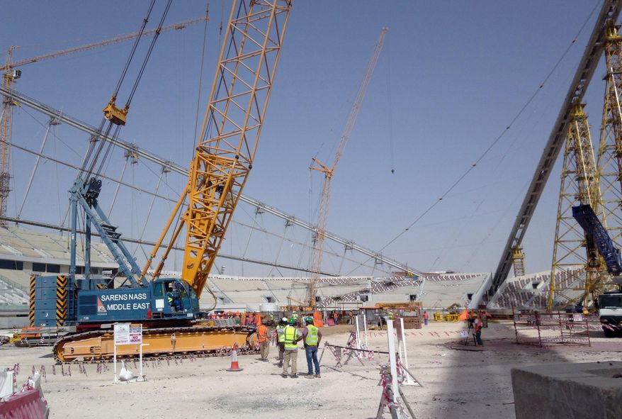 FILE - In this Nov. 9, 2014 file photo, construction work is under way at the Khalifa Stadium in Doha, Qatar. An investigation into why a British man fell to his death on a Qatar World Cup site has raised concerns about stadium roof safety. World Cup organizers on Thursday, June 22, 2017 released partial findings of the assessment of the accident at the Khalifa International Stadium, but said the full report cannot be released while local authorities continue their own investigation. (AP Photo/Rob Harris, File)
