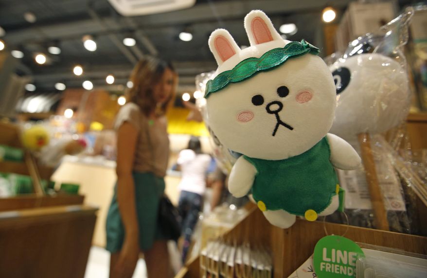 A customer selects merchandise at Line Village in Bangkok, Thailand, Thursday, June 22, 2017. Thailand&#39;s most popular text-messaging service will open its doors to the public Friday with an extravagant digital theme park called Line Village Bangkok. (AP Photo/Sakchai Lalit)