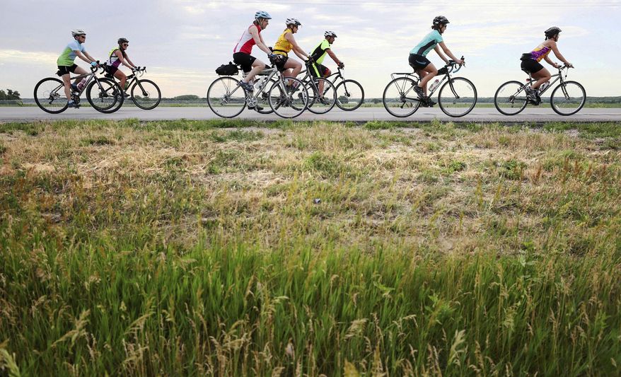 Cyclists head out on Hwy. 281 to start their ride during the 2017 Tour de Nebraska Wednesday, June 21, 2017, at the Howard County Fairgrounds in St. Paul, Neb. (Andrew Carpenean/The Grand Island Independent via AP)
