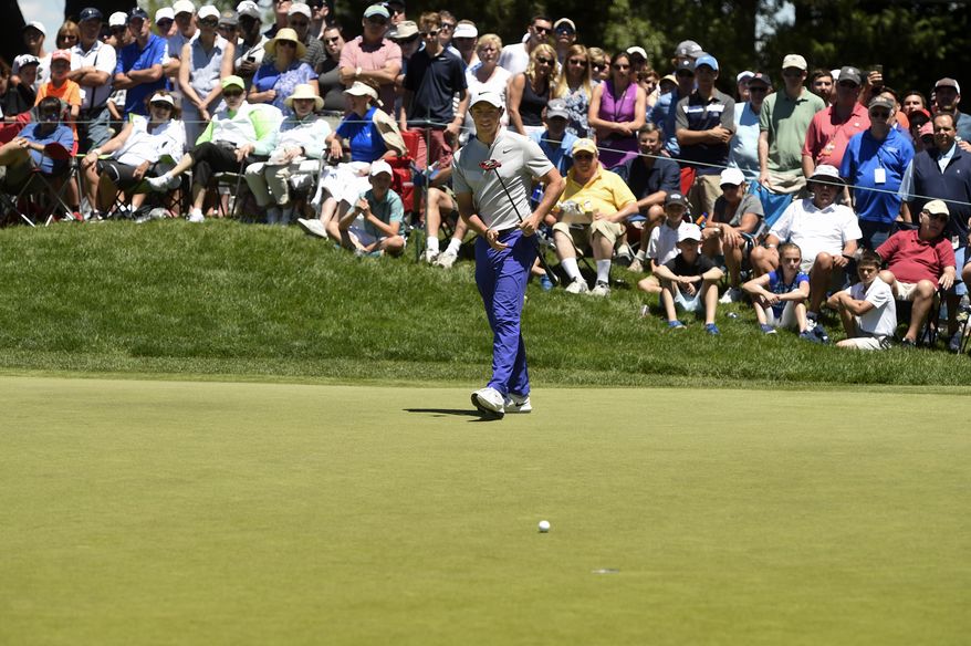 Rory McIlroy walks towards his putt after missing a birdie attempt on the ninth hole during the first round of the Travelers Championship golf tournament Thursday, June 22, 2017, in Cromwell, Conn. (John Woike/Hartford Courant via AP)