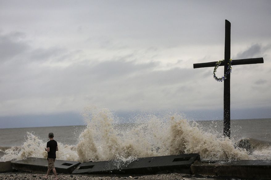 Tommy Bomar, of High Island, Texas, checks out the waves as a result of Tropical Storm Cindy on Thursday, June 22, 2017, in Bolivar Peninsula, Texas. (Elizabeth Conley/Houston Chronicle via AP)