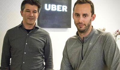 FILE - In this Thursday, Aug. 18, 2016, file photo, then-Uber CEO Travis Kalanick, left, and Anthony Levandowski, co-founder of Otto, pose for a photo in the lobby of Uber headquarters, in San Francisco. In a court filing on Thursday, June 22, 2017, Uber said it hired Levandowski, a former Google engineer now accused of stealing trade secrets, even though the company knew at the time that he had information that didn't belong to him. Uber hired Levandowski in August 2016 to head Uber's project on self-driving cars, something he worked on at Google. Uber is asserting that Kalanick told Levandowski not to bring the material with him and that Levandowski assured the company that he had destroyed the five discs containing Google information. Uber recently fired Levandowski. (AP Photo/Tony Avelar, File)