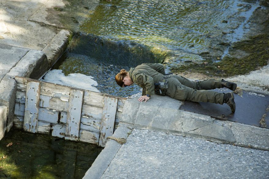 FILE - In this Thursday, May 18, 2017, file photo, Los Angeles County Sheriff and South Pasadena Police departments search a drain in the Arroyo Seco wash in South Pasadena, Calif., looking for 5-year-old Aramazd Andressian, Jr., who has been missing since April 22. The Los Angeles County Sheriff's Department says the father of a 5-year-old who has been missing for two months has been arrested on suspicion of his son's murder. The department said in a statement that 35-year-old Aramazd Andressian Sr. was arrested on Friday, June 23, 2017, afternoon in Las Vegas and is being held there on $10 million bail. (Sarah Reingewirtz/Los Angeles Times via AP, File)