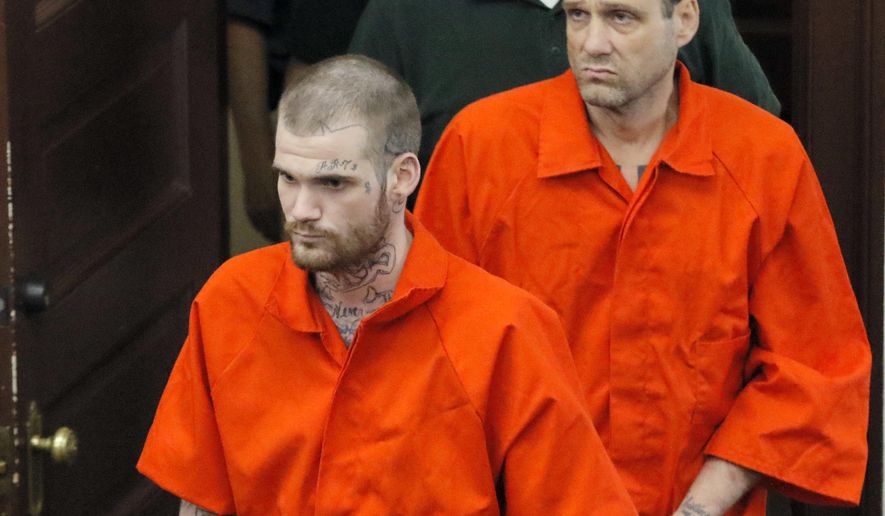 Ricky Dubose, front, and Donnie Russell Rowe enter the Putnam County courthouse on Wednesday, June 21, 2017, in Eatonton, Ga. The two inmates accused of killing their guards on a Georgia prison bus were brought before a judge on charges including murder, felony escape and hijacking a motor vehicle. (Bob Andres/Atlanta Journal-Constitution via AP, Pool)