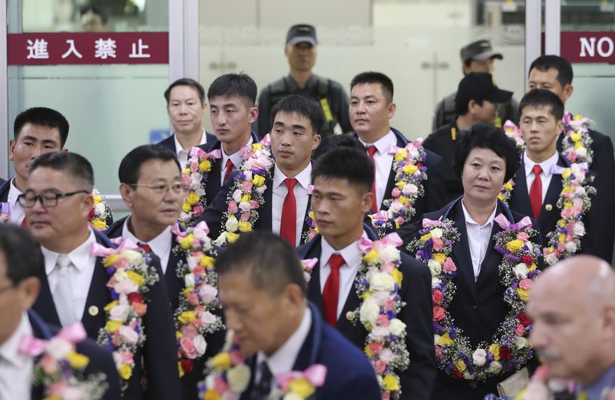 North Korean taekwondo demonstration team members and other officials arrive at Gimpo International Airport in Seoul, South Korea, Friday, June 23, 2017. The team has arrived in South Korea for its first performances in the rival country in 10 years. (AP Photo/Lee Jin-man)