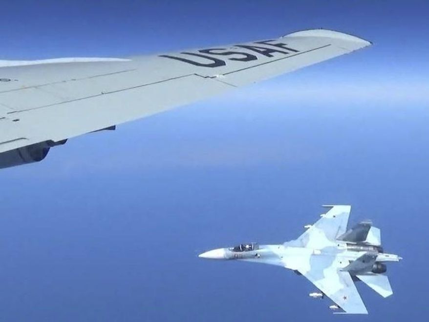 This is a dramatic photo of a Russian jet coming within a few feet of a U.S. Air Force reconnaissance jet over the Baltic Sea, June 19, 2017, in a maneuver that has been criticized as unsafe. The photographs released Friday, June 23, 2017, show the Russian SU-27 coming so close to the wing of the U.S. RC-135U that the Russian pilot can be seen sitting in the cockpit in some images. (Master Sgt Charles Larkin Snr/U.S. European Command via AP) ** FILE **