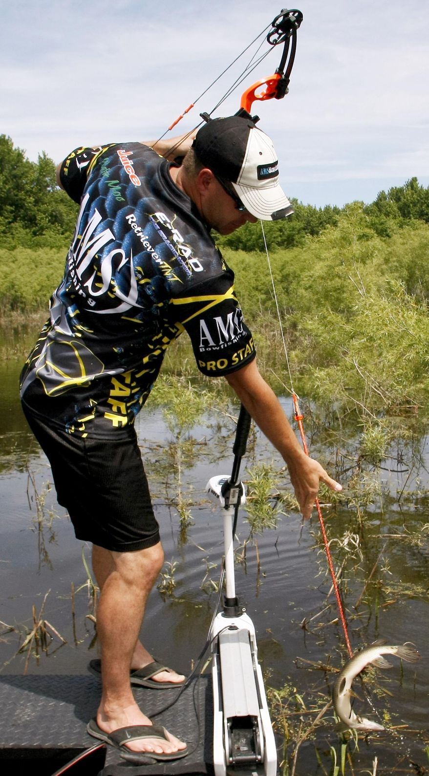ADVANCE FOR USE SATURDAY, JUNE 24 - In this Sunday, June 4, 2017 photo, Kenny Nachtman, of Bellevue, Iowa, pulls in a shortnose gar while bowfishing on the Mississippi River near Bellevue, Iowa. Some Iowa fishermen are turning to bowfishing to catch rough fish, which are less desirable to sport anglers (Adam Rang/Telegraph Herald via AP)