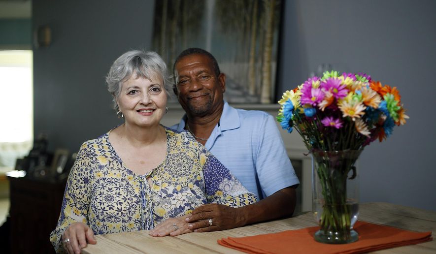 This photo taken June 14, 2017, shows Myra Clark Foster and Howard Foster who stopped dating years ago due to societal pressures and met again many years later and are now married. Decades after racism caused their breakup, the two reconnected at Sharon Woods Metro Park on a fall day in 2013, and they held hands across a picnic table as they talked like they’d never been apart. “It was that dream you just never thought would come true ... there she was,” Howard said. (Kyle Robertson /The Columbus Dispatch via AP)